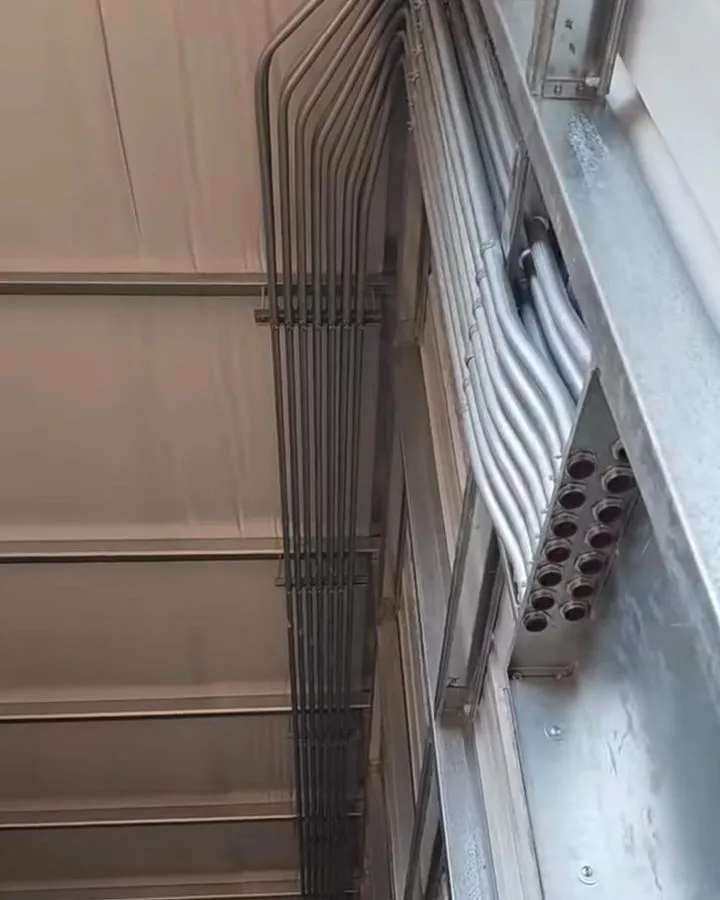 Parallel conduit runs along a commercial wall