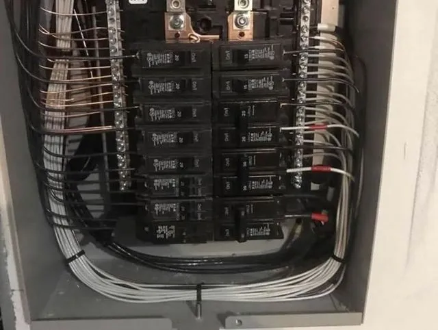 Breaker panel with every wire dressed neatly around the edges