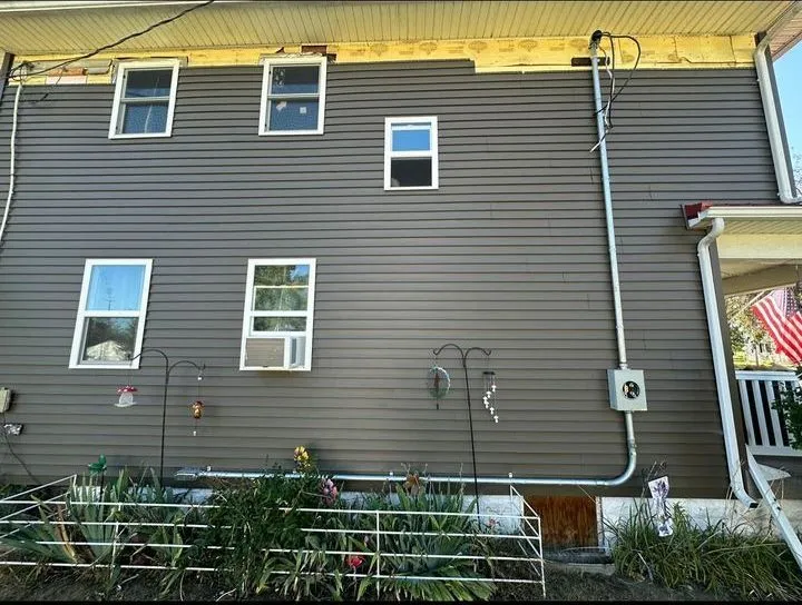 New electrical service run on the side of a two-story house