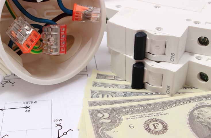 Electrical components and wiring next to circuit breakers, including AFCI and GFCI devices, alongside U.S. dollar bills on technical diagrams—highlighting the importance of electrical safety in installations.